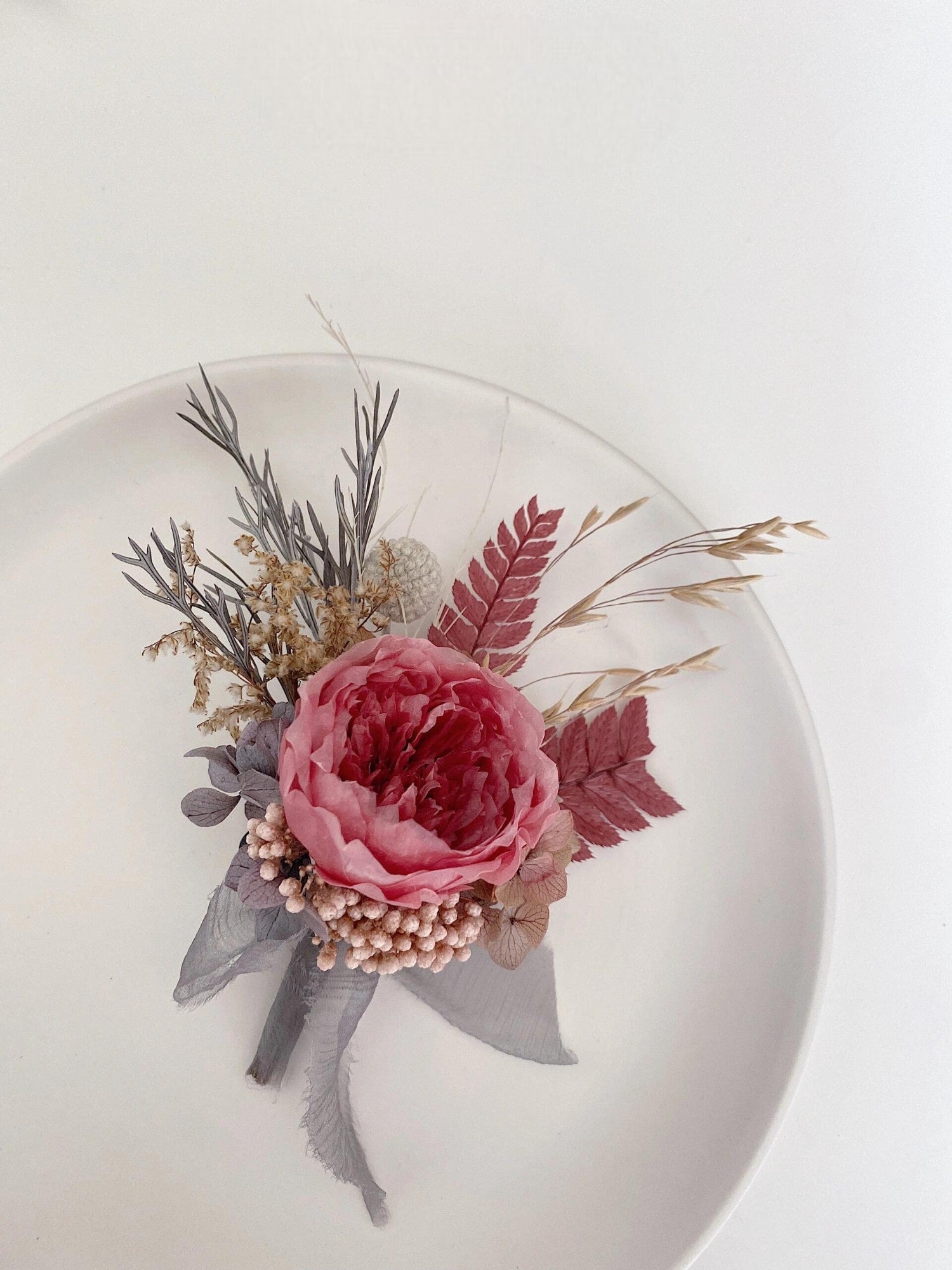 Sophisticated boutonniere with preserved dusty rose peony
