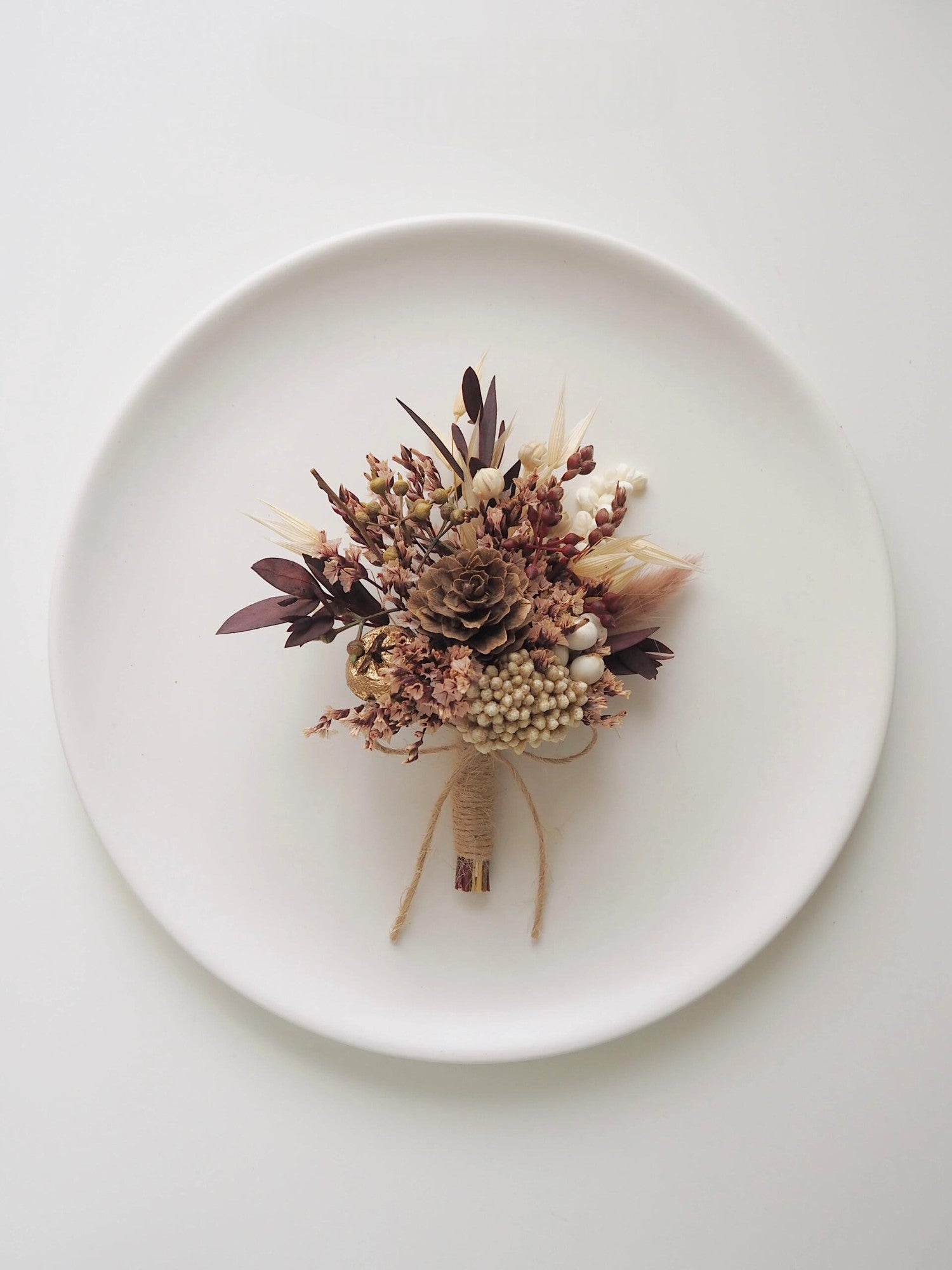 Rustic pinecone and berry boutonniere with dried florals
