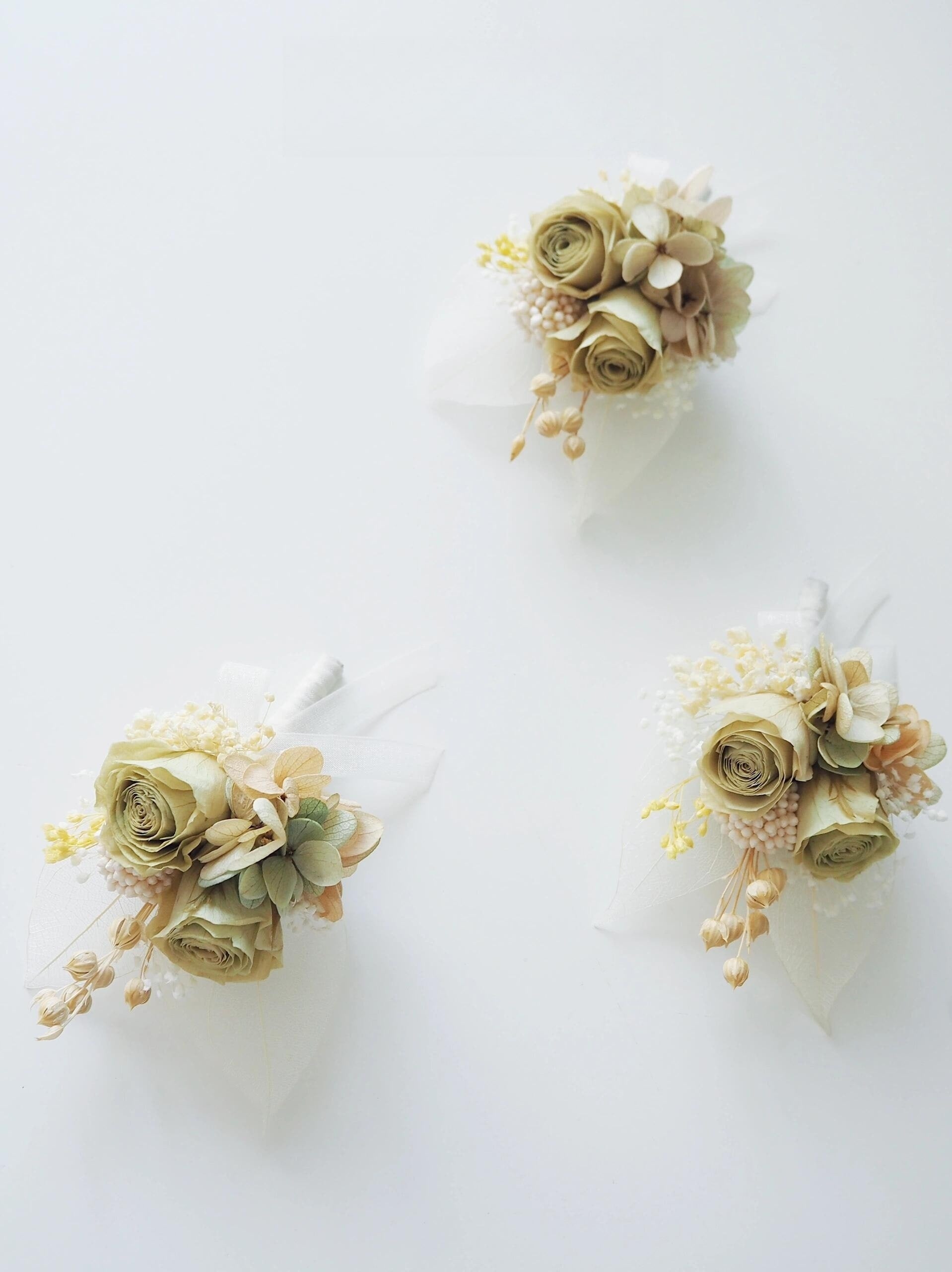 Elegant preserved cream rose boutonniere with soft floral accents
