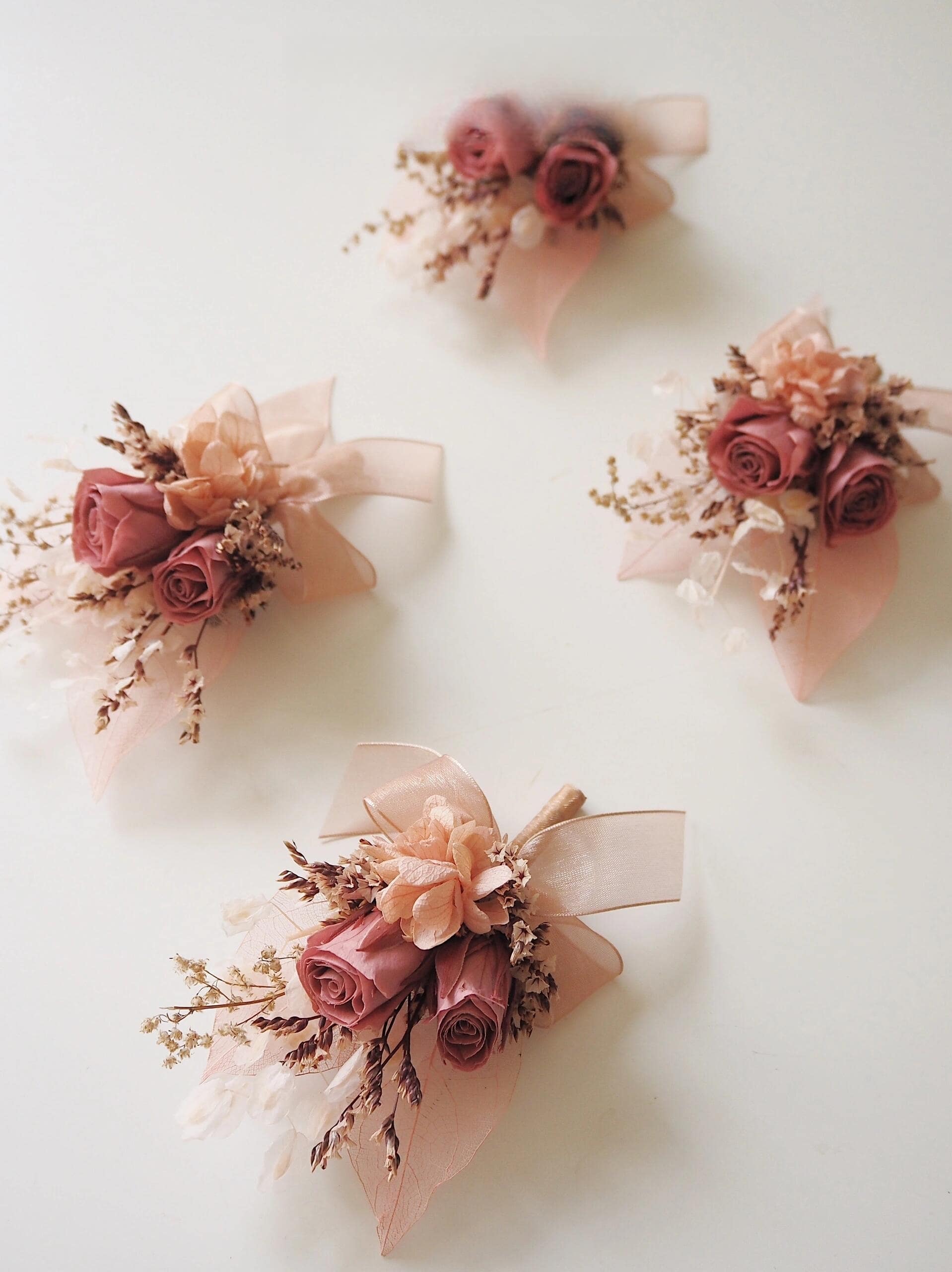 Wedding boutonniere with preserved dusty rose flowers and soft ribbon
