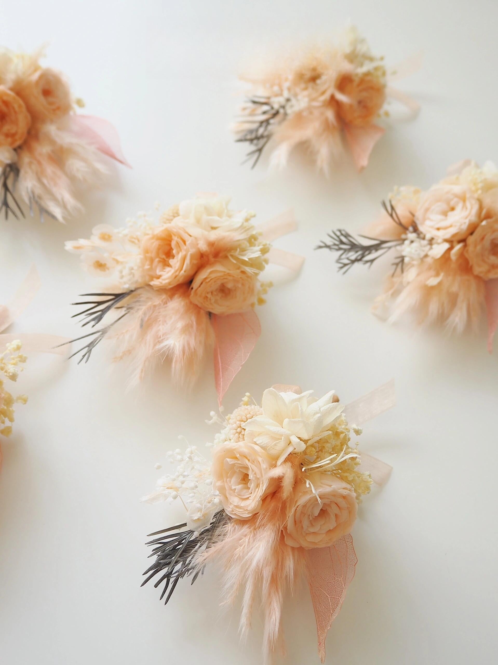 Elegant preserved peach ranunculus boutonniere with pampas grass
