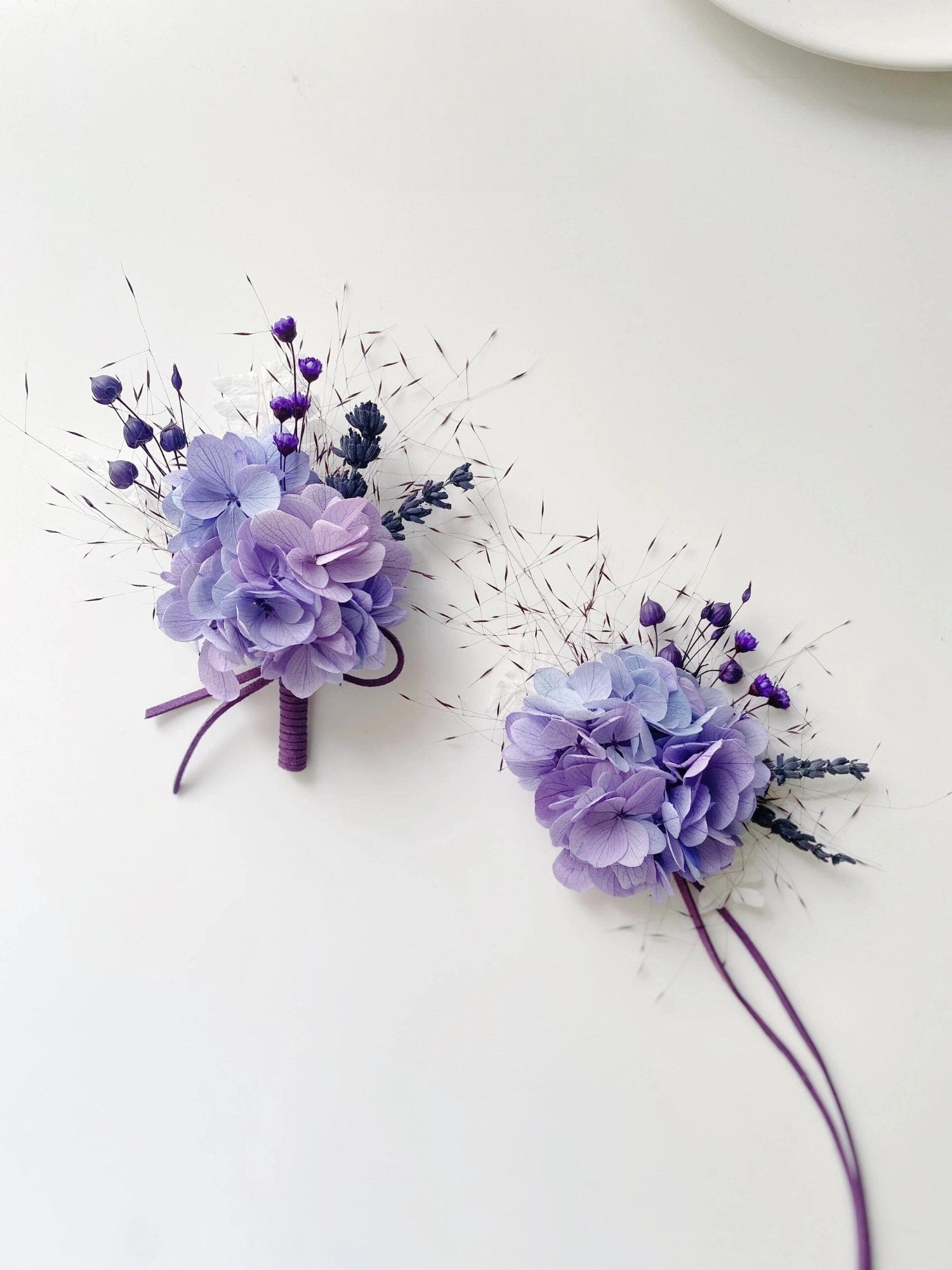 Wedding boutonniere and corsage set in lavender hues.
