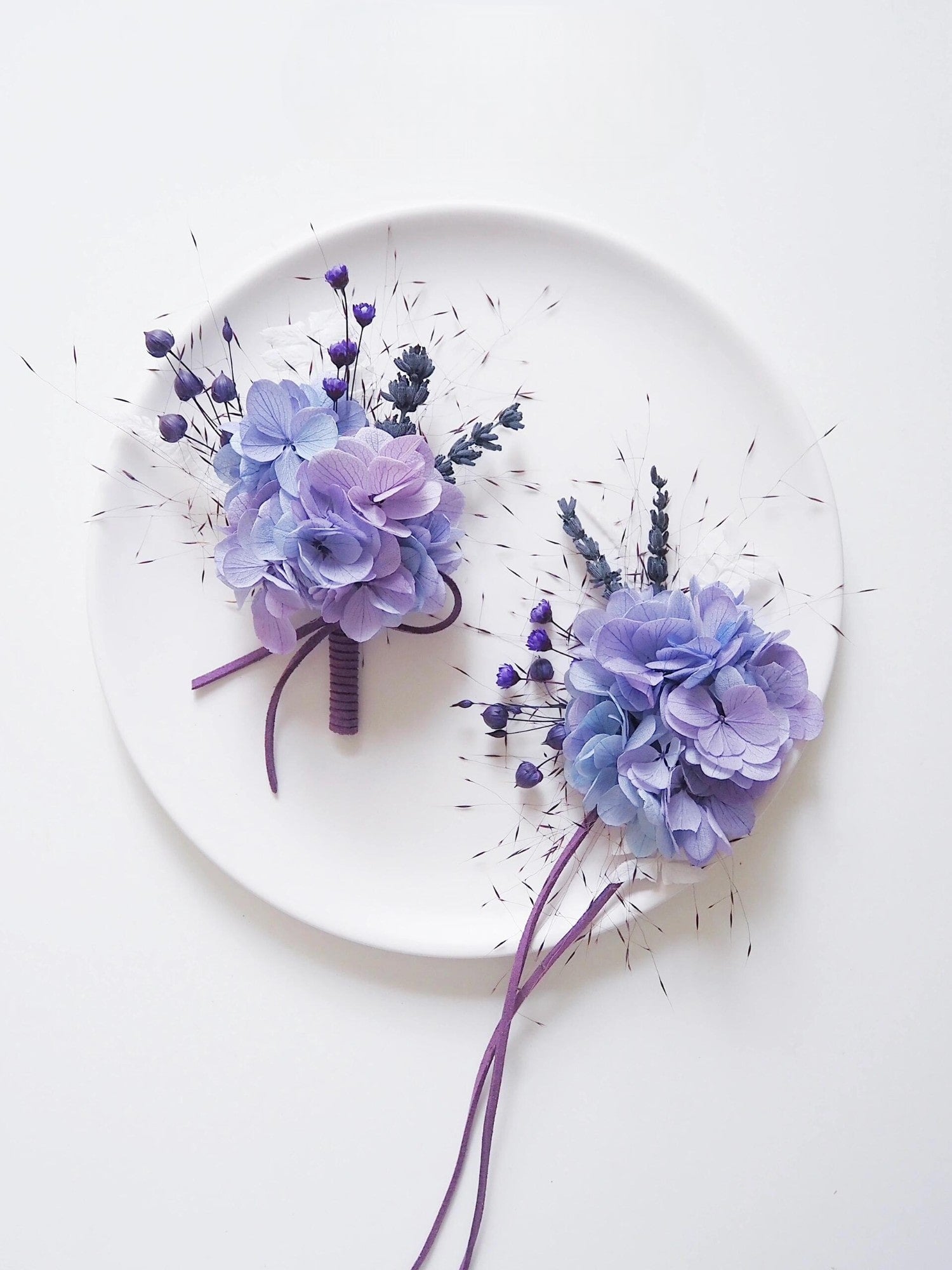 Lavender hydrangea boutonniere with purple berry accents.
