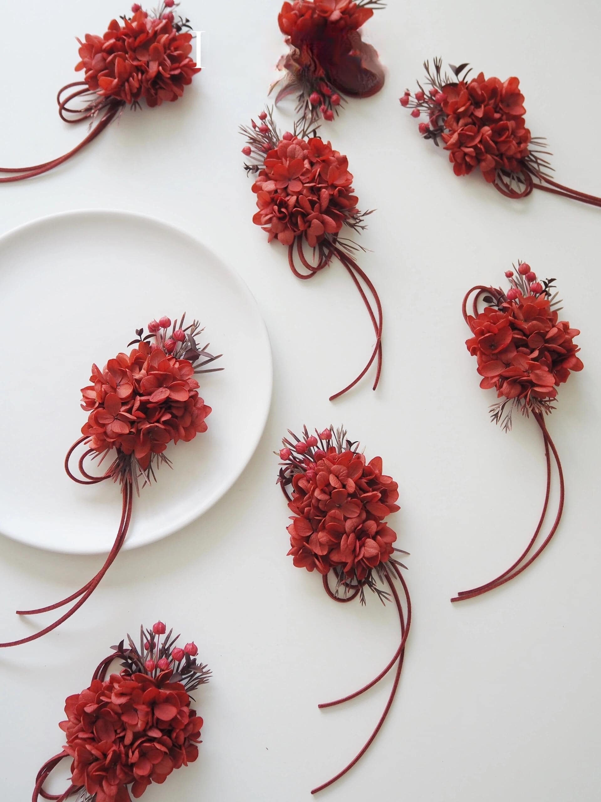 Bold preserved red hydrangea corsage with berry accents
