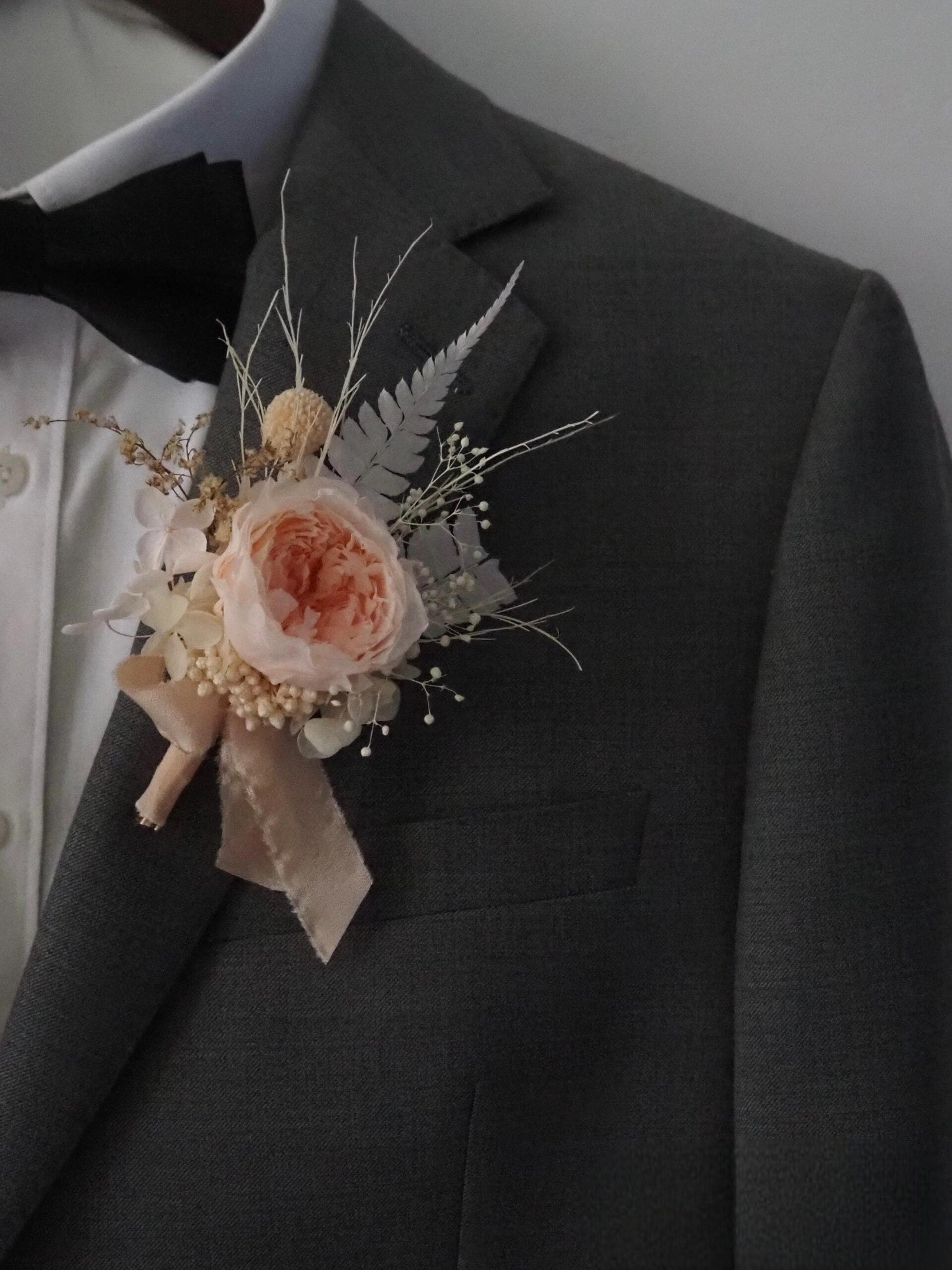 Romantic wedding boutonniere with preserved blush peony
