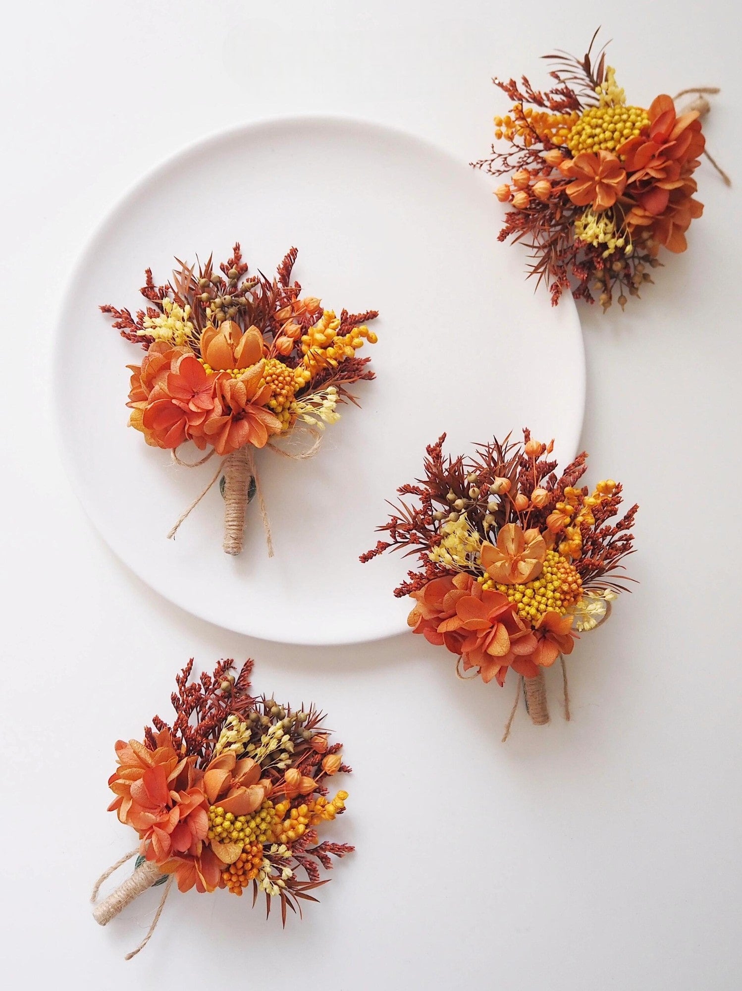 Close-up of autumn terracotta boutonniere.
