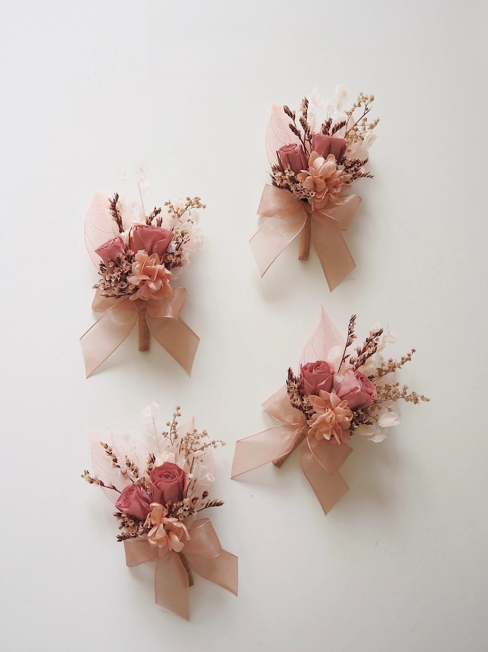 Romantic preserved flower boutonniere with dusty rose and peach tones
