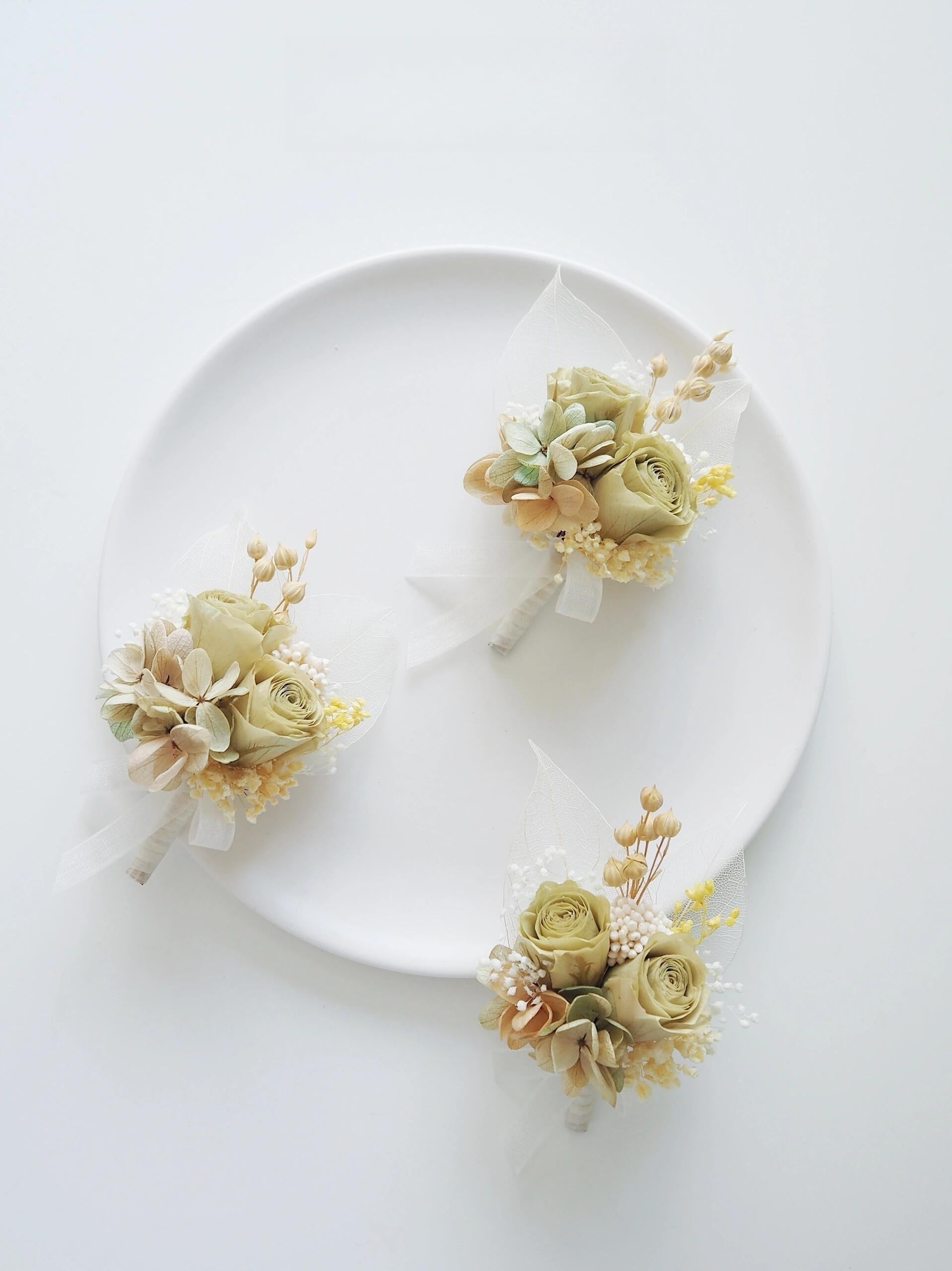 Wedding boutonniere featuring preserved cream roses and hydrangeas
