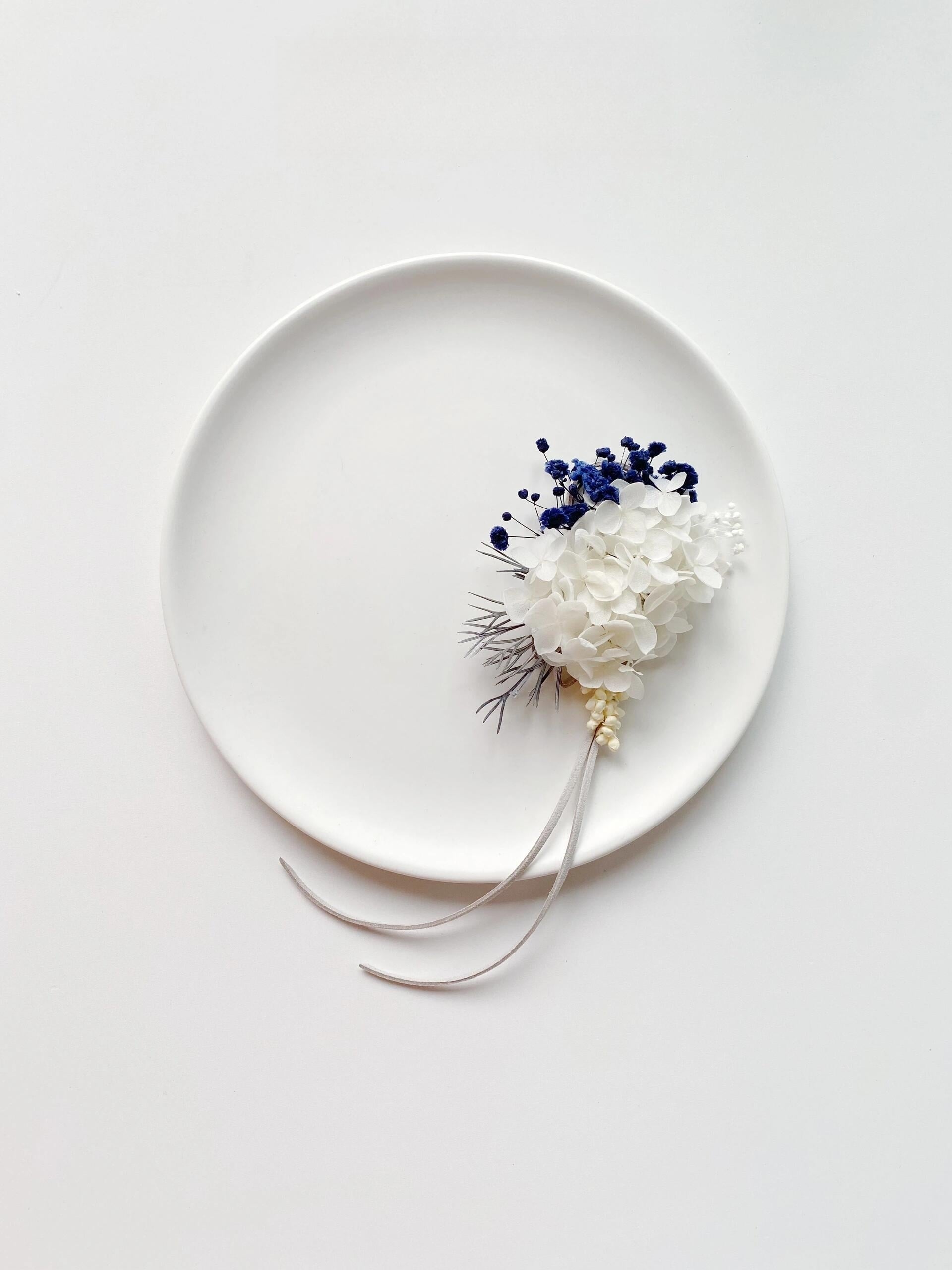 Wedding corsage with white hydrangeas and blue accents
