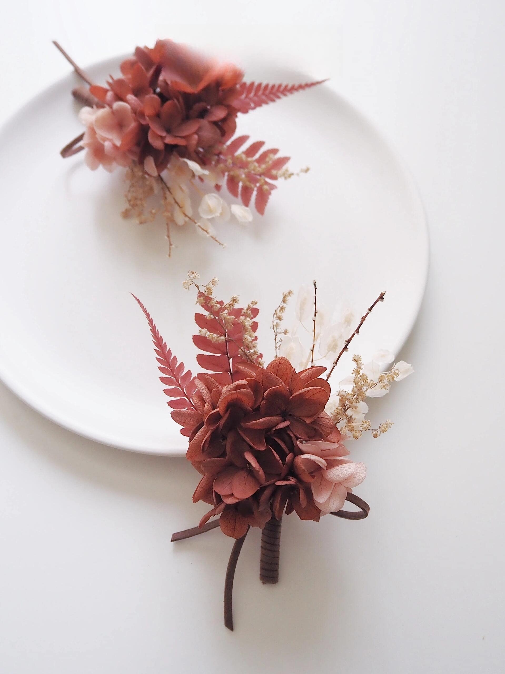 Wedding boutonniere with preserved rust hydrangea and fern accents
