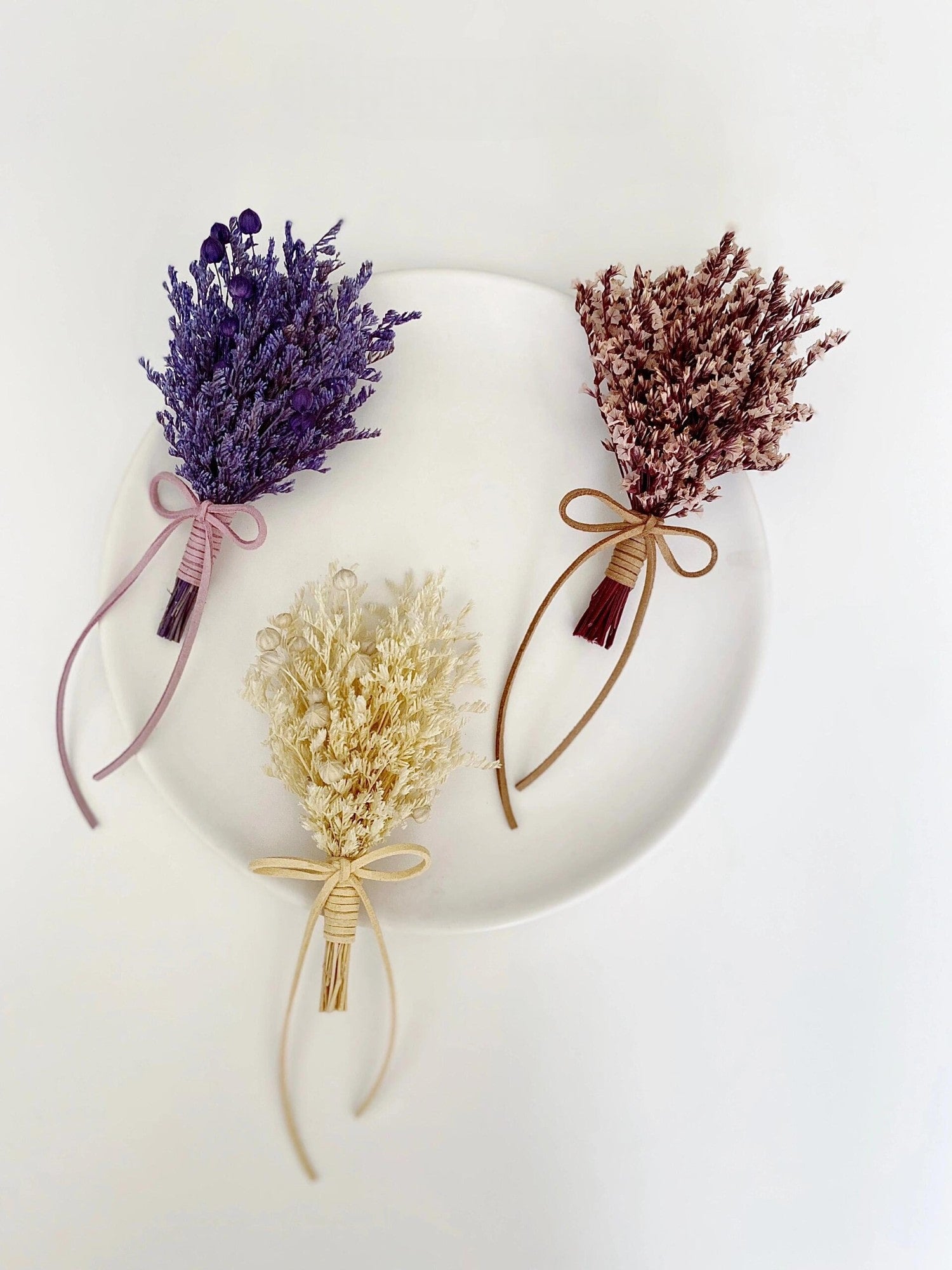 Lavender, statice, and dried flower boutonniere collection for weddings
