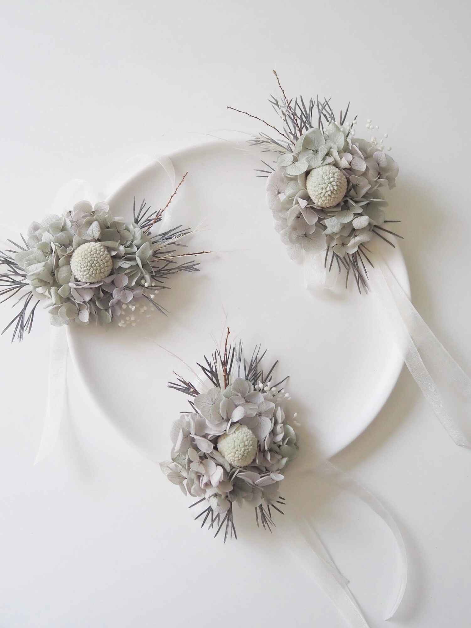 Neutral gray corsage with soft hydrangea petals.
