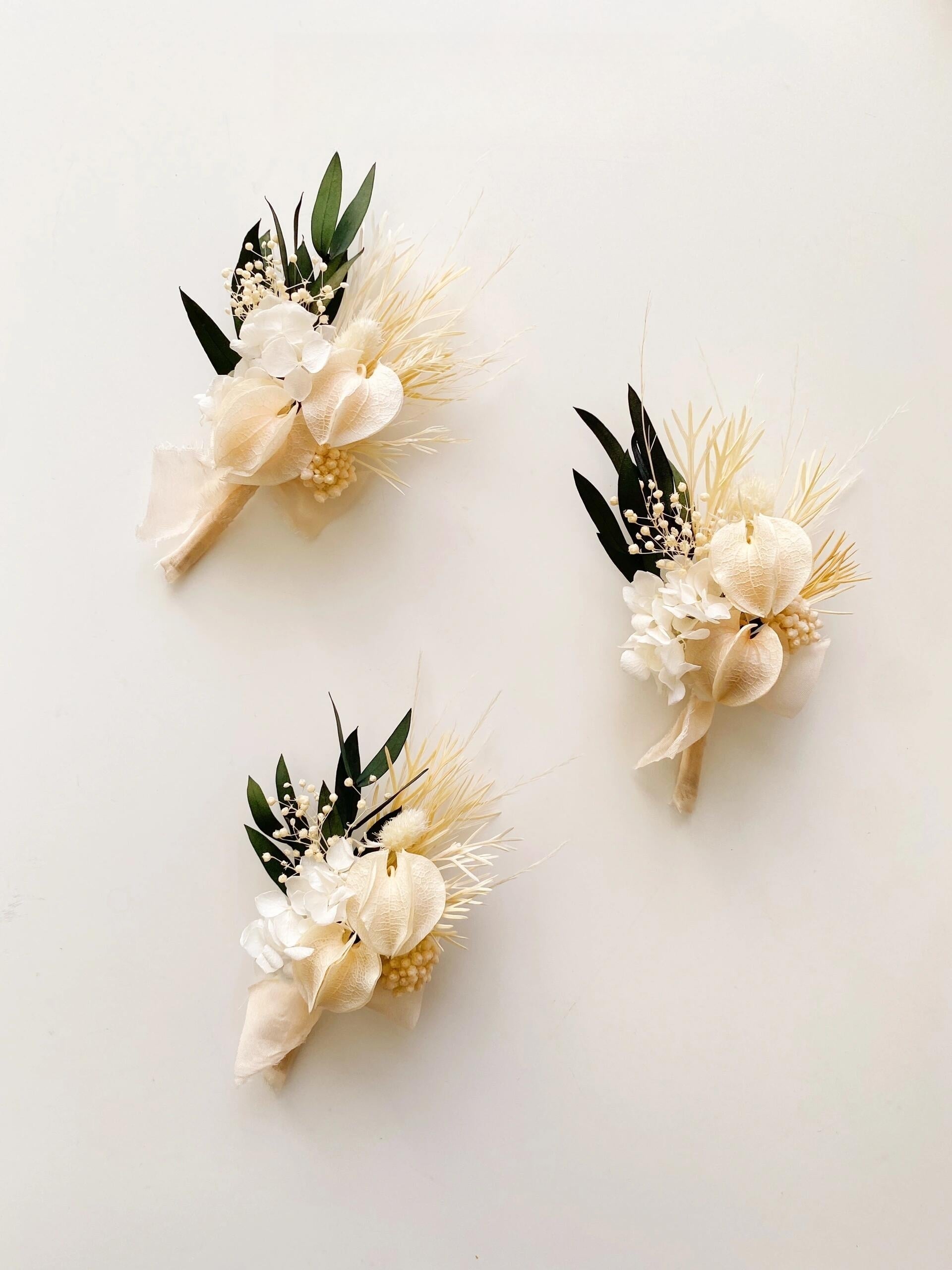 Ivory calla lily boutonniere with preserved white hydrangea

