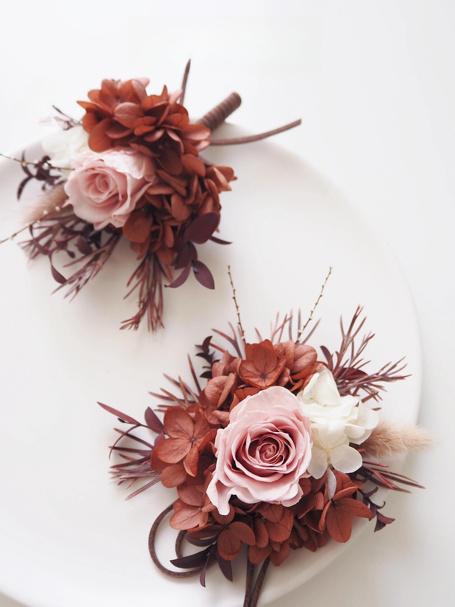 Elegant wedding boutonniere and corsage set with preserved blush roses and rust hydrangeas
