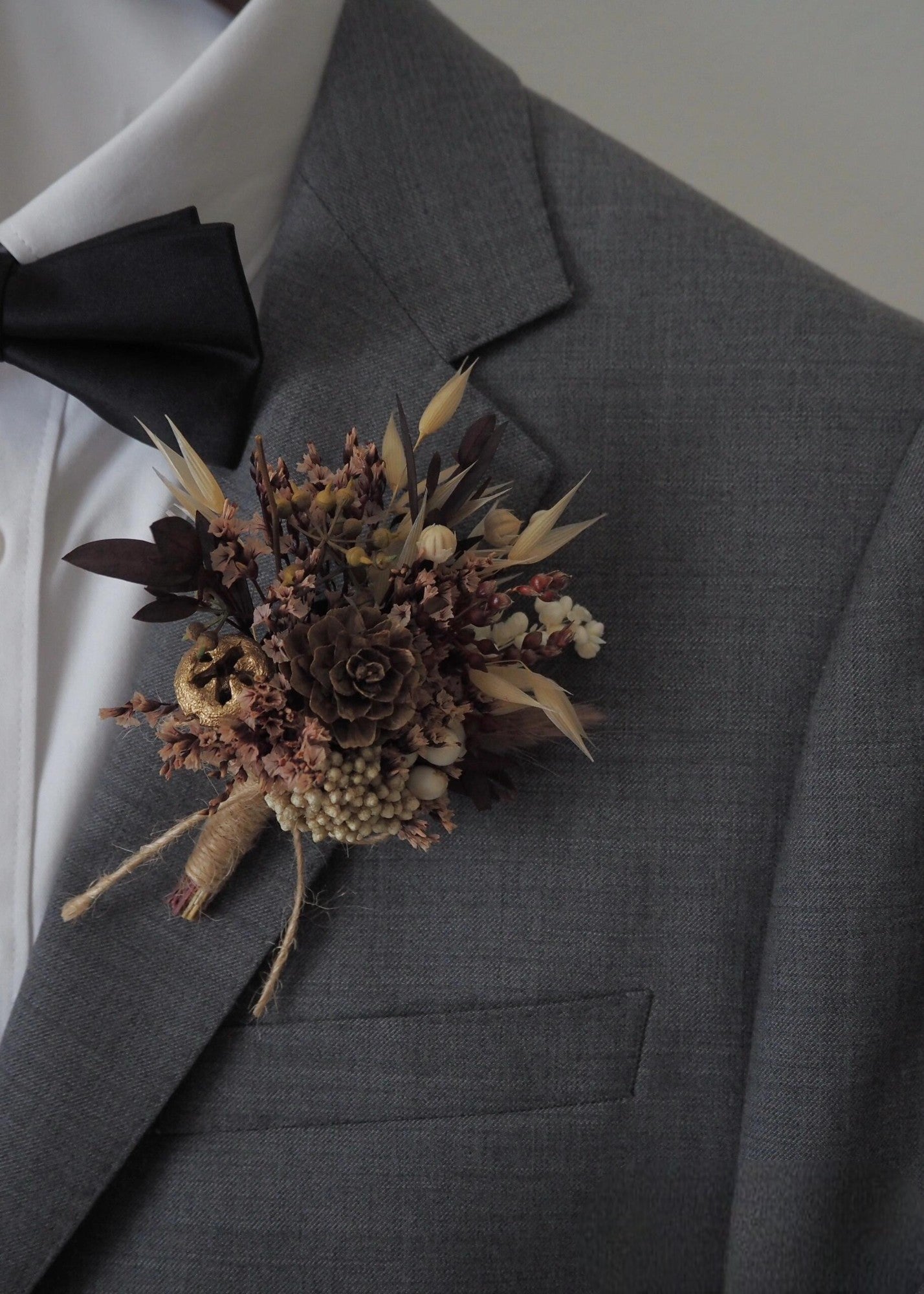 Natural pinecone boutonniere with preserved flowers
