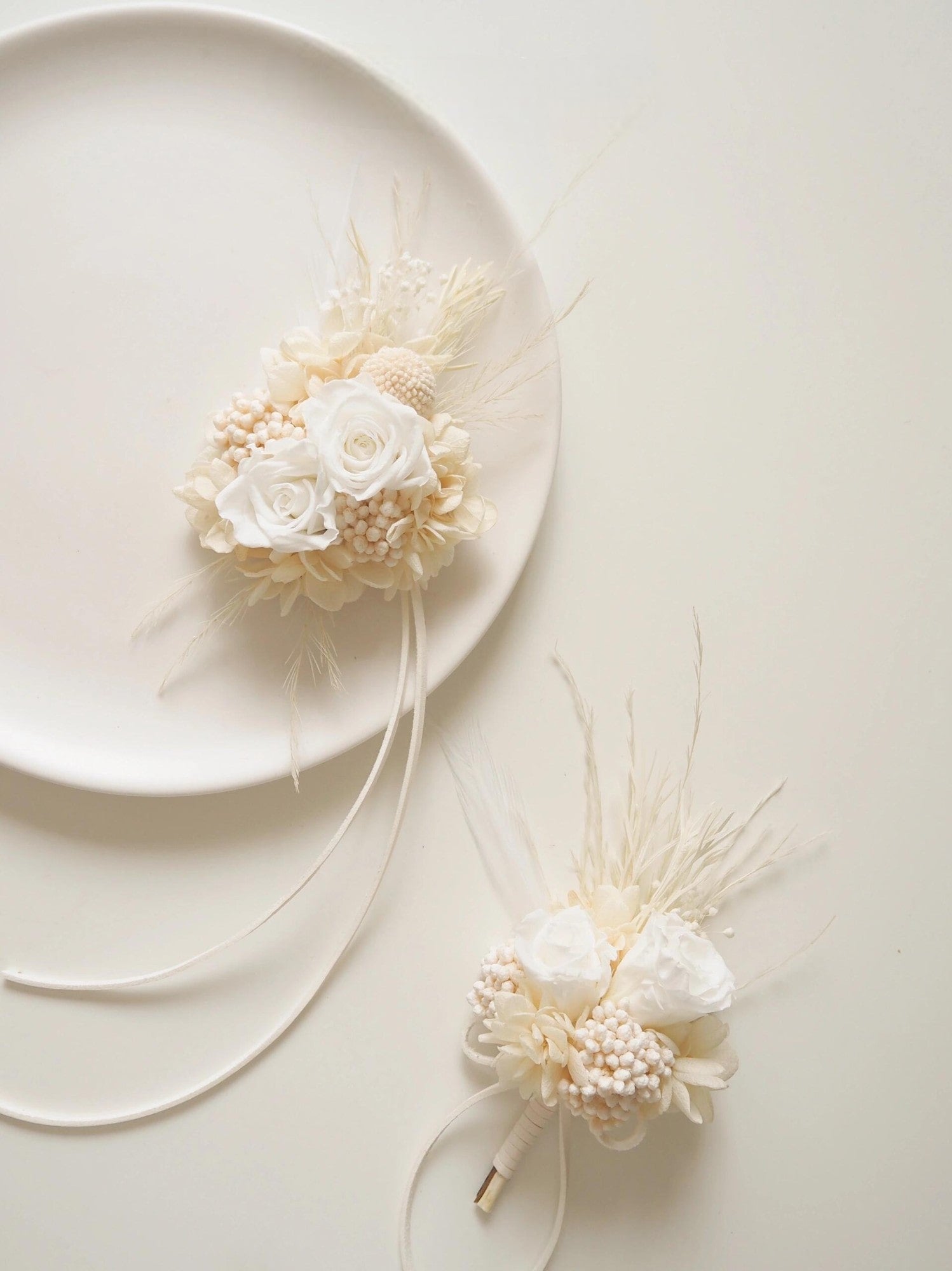 Elegant ivory boutonniere and corsage set with preserved flowers and pearls
