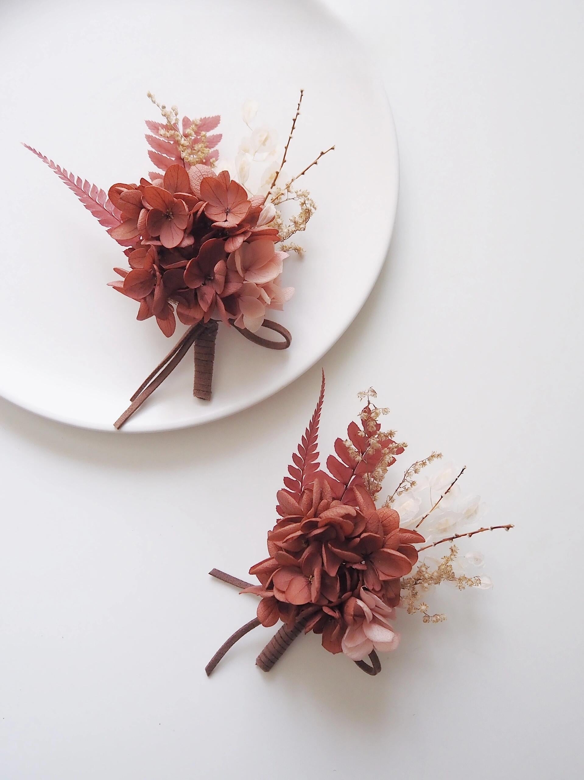 Rust hydrangea and fern preserved flower boutonniere for weddings
