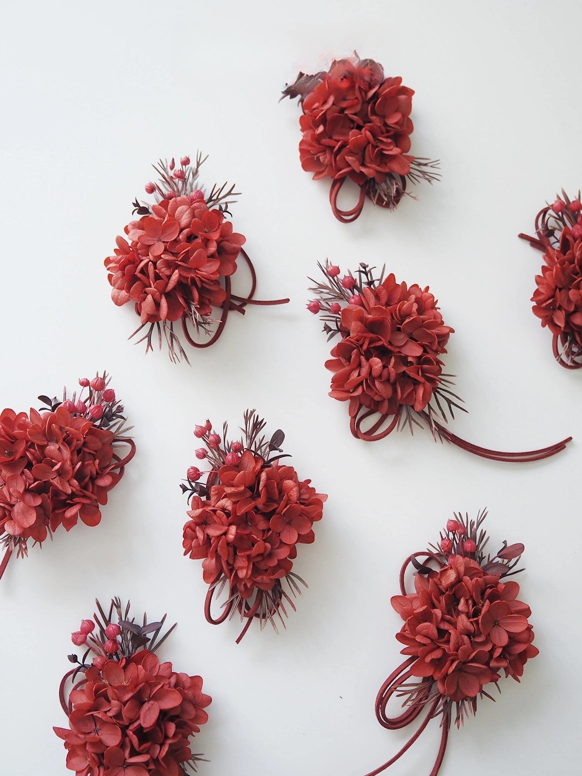 Preserved flower corsage featuring red hydrangeas and matching ribbon
