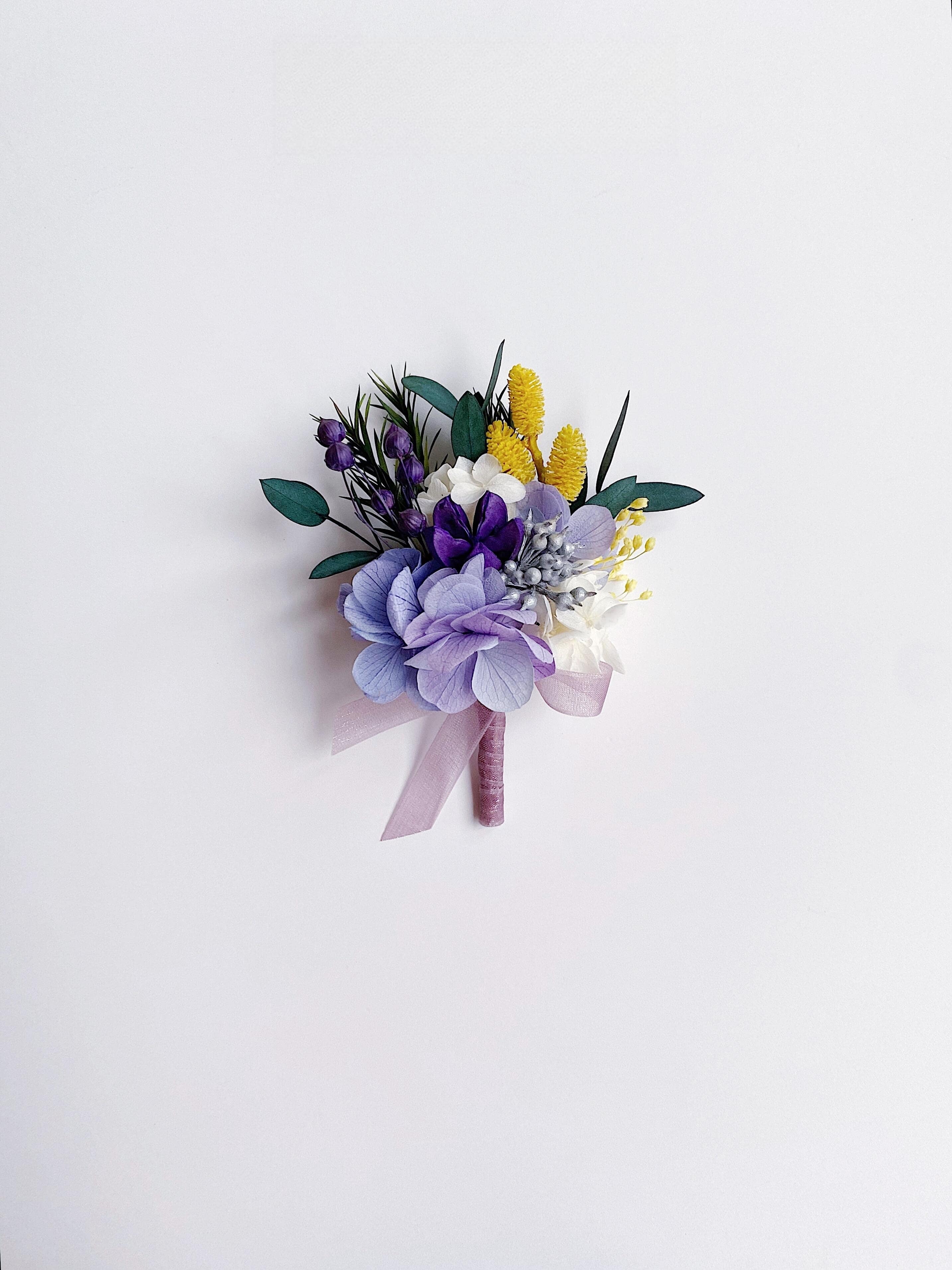 Wedding boutonniere with preserved lavender and purple flowers
