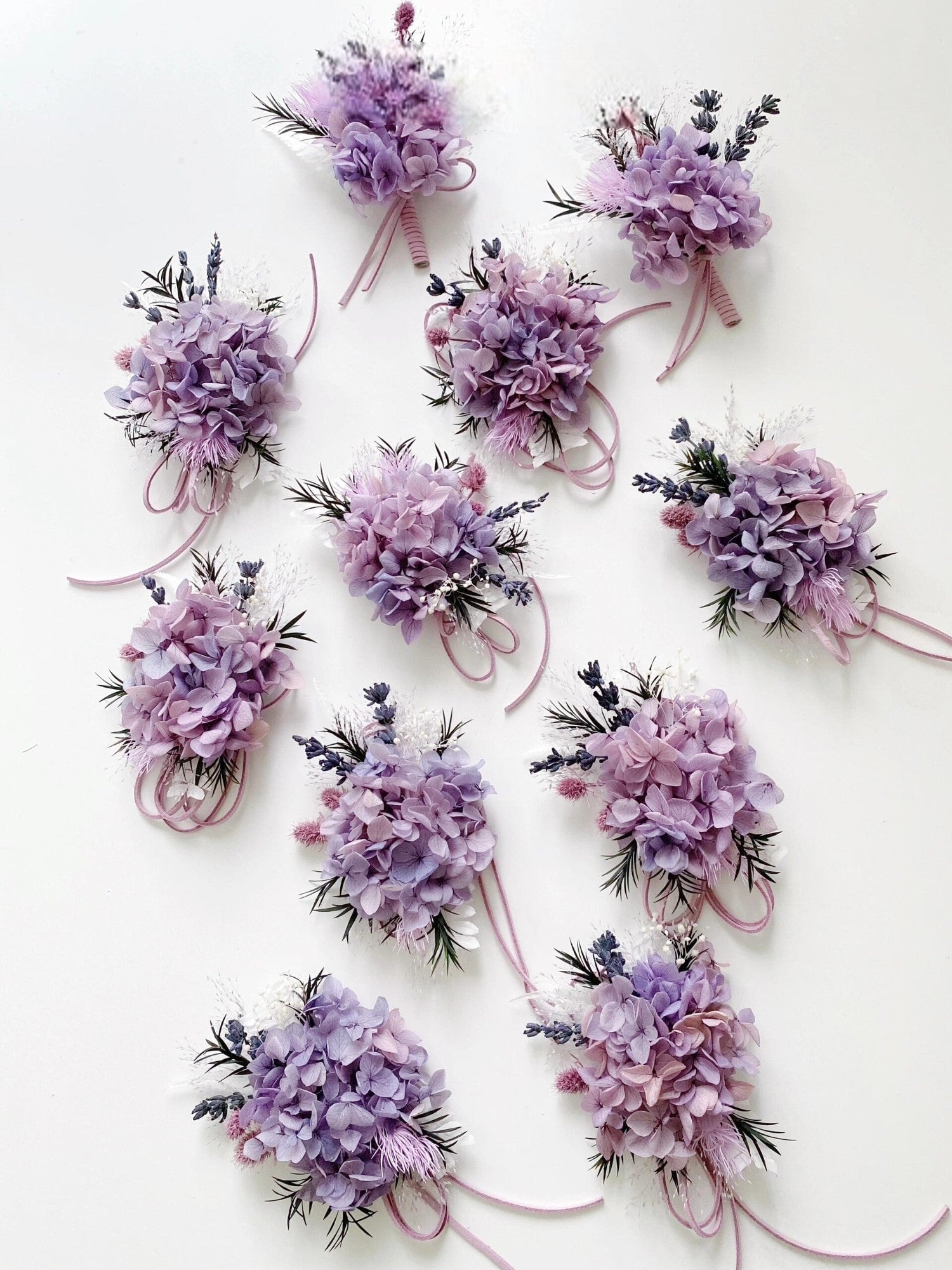 Purple hydrangea and lavender boutonniere and corsage, ideal for weddings and formal events.